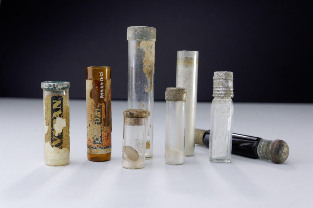 Objects found at the former camp grounds. Medicine vials, PMM